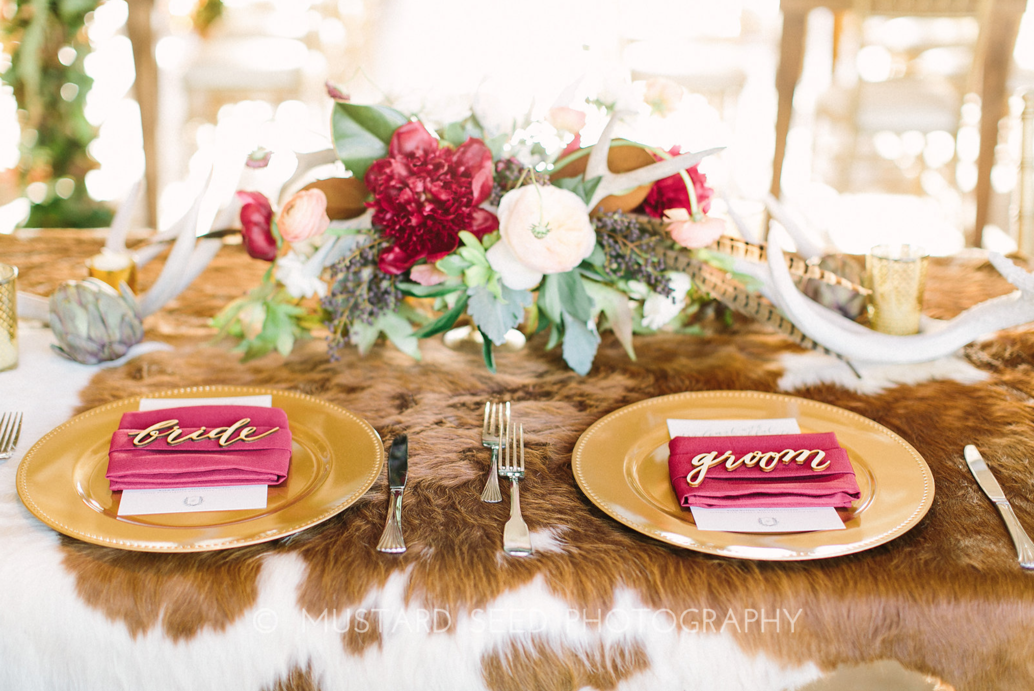 Sweetheart table with cowhide and floral by Maxit Flower Design