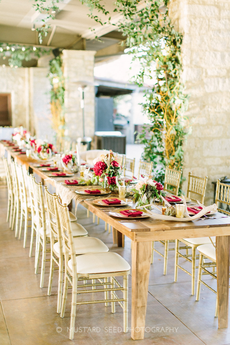 Wooden Head Table with floral arrangements and greenery