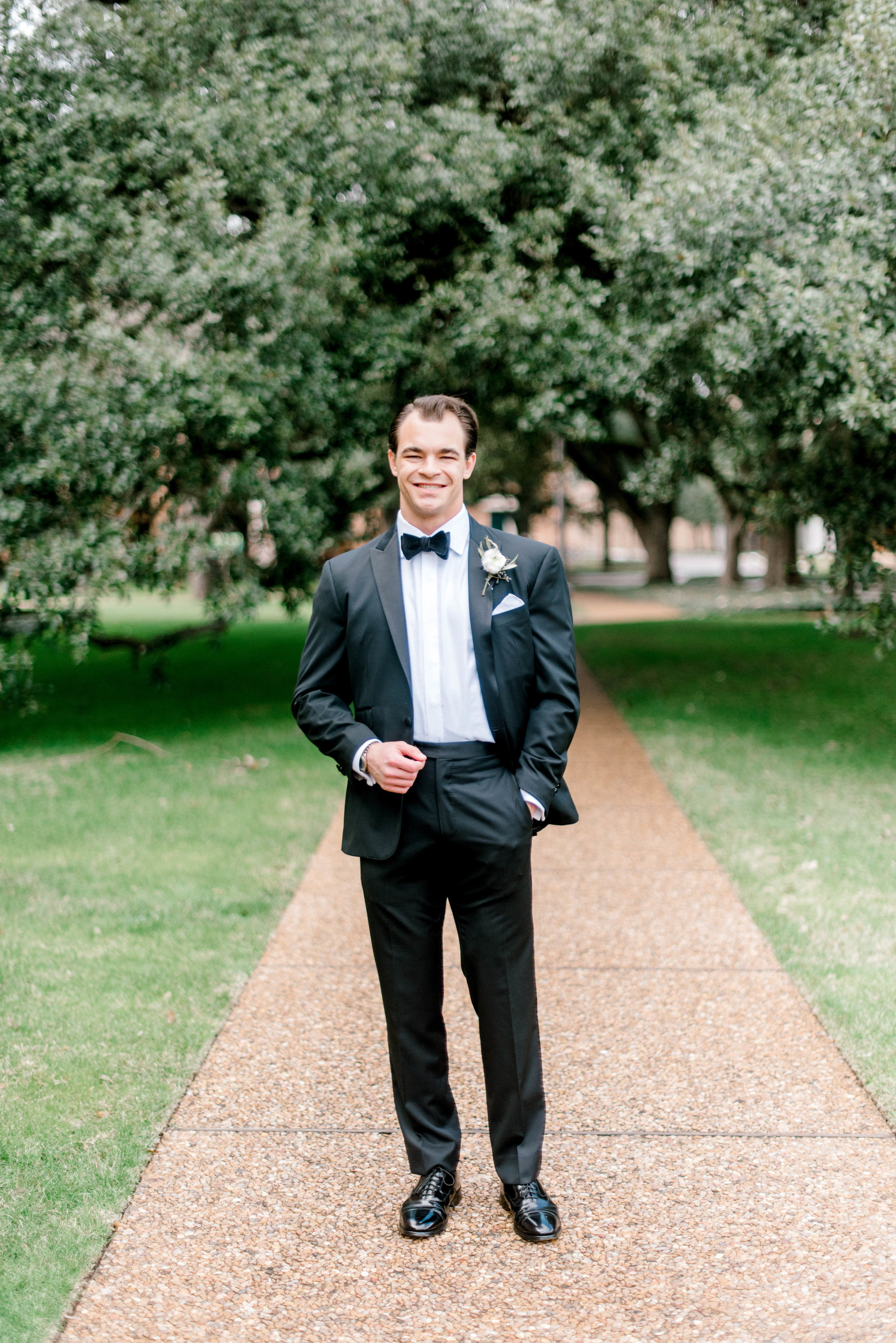 wedding-details-photography-dana-fernandez-groom-tux-bowtie-black-boutonniere-floral-greenery-by-maxit-flower-design-houston-texas