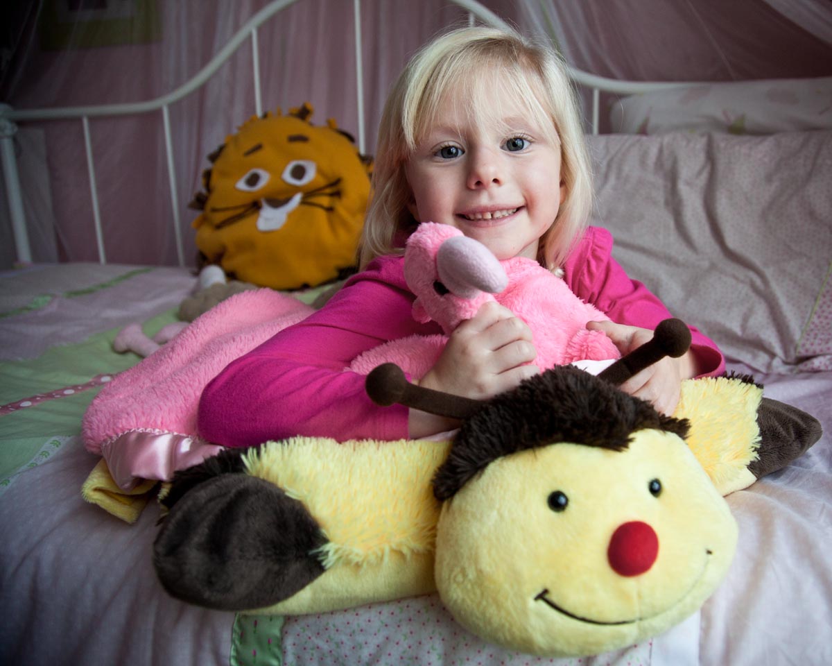 Portrait of a child with stuffed animals by Madison WI photographer Nick Wilkes