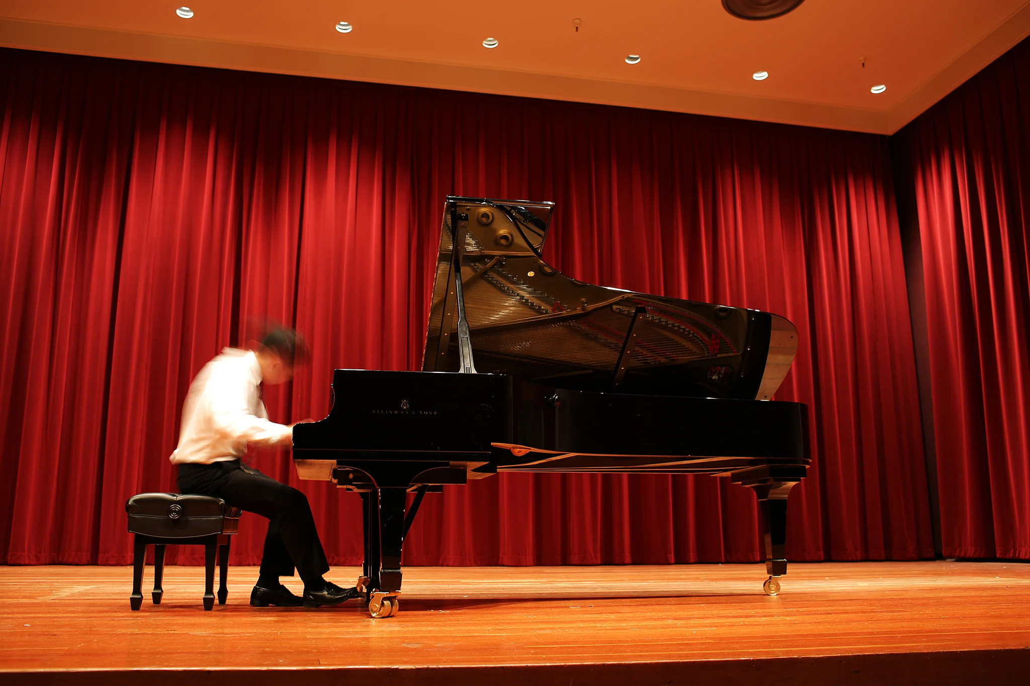 Alex Chien, one of the winners of the San Francisco Young Pianist Competition, warms up before a performance in Knuth Hall on Sept 6.