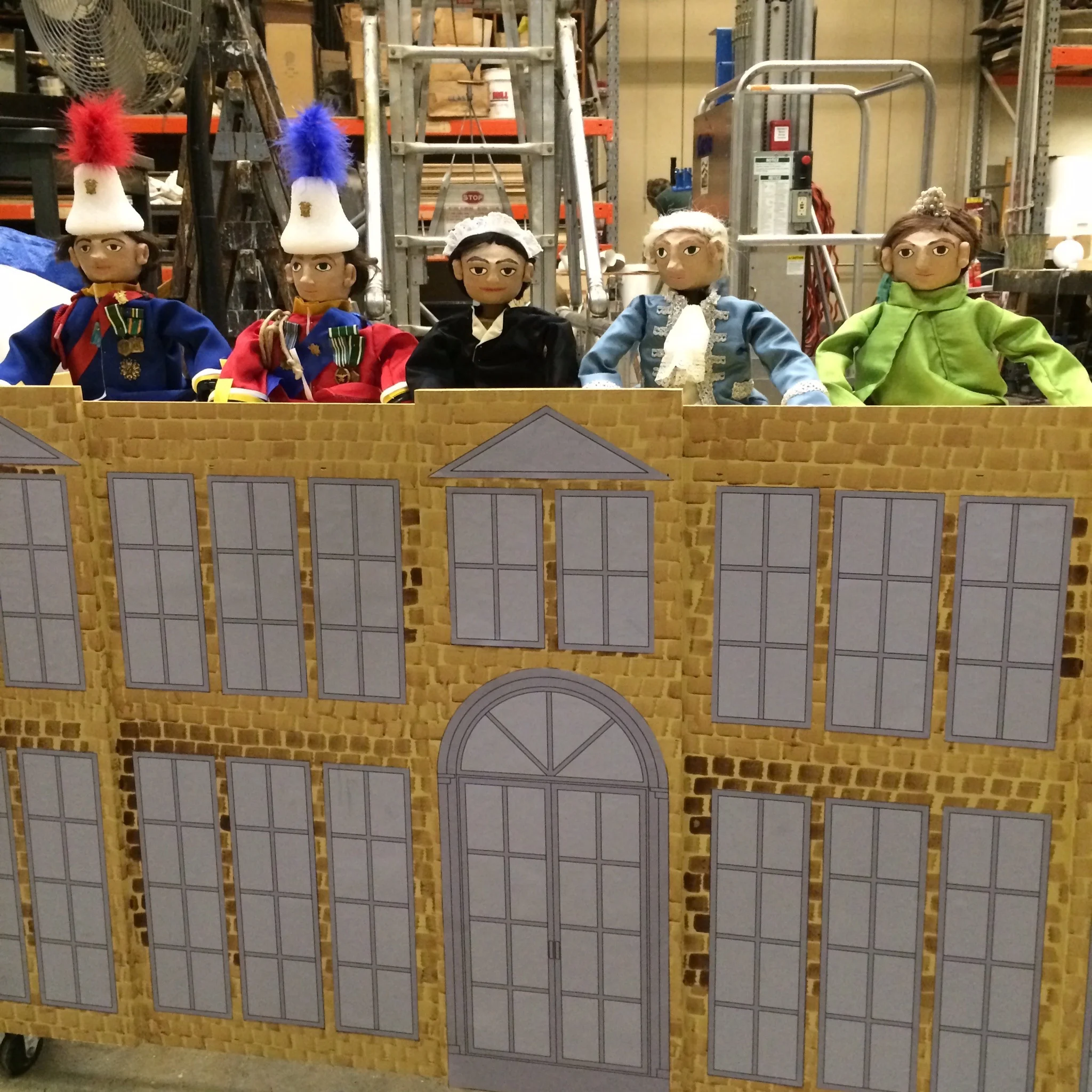A closer backstage look of the puppets after they were attached to Buckingham Palace.