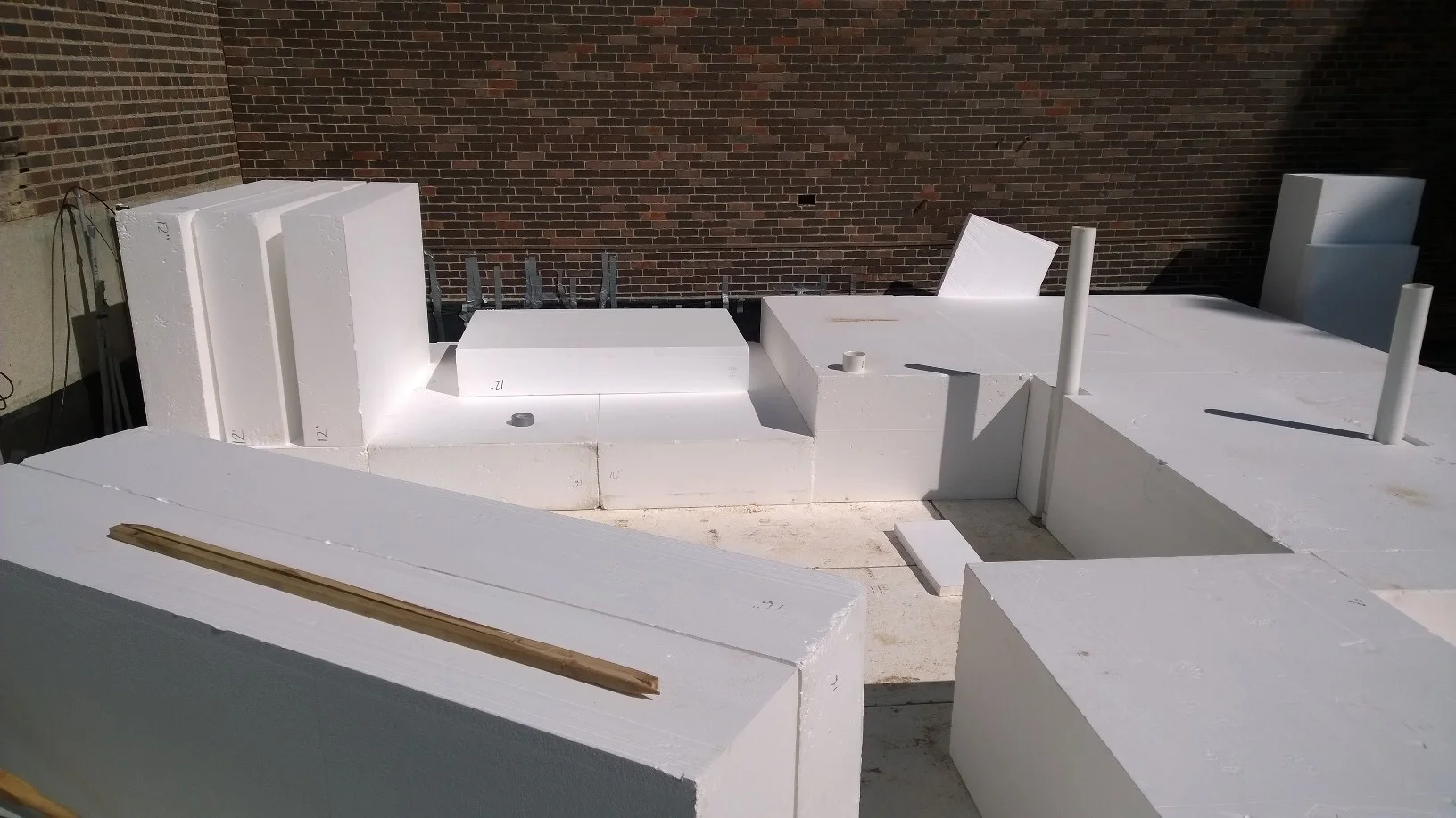 The geofoam base was installed in layers, paying careful attention to shape the product around our future site uses including planting areas, the greenhouse and interior masonry structures. 