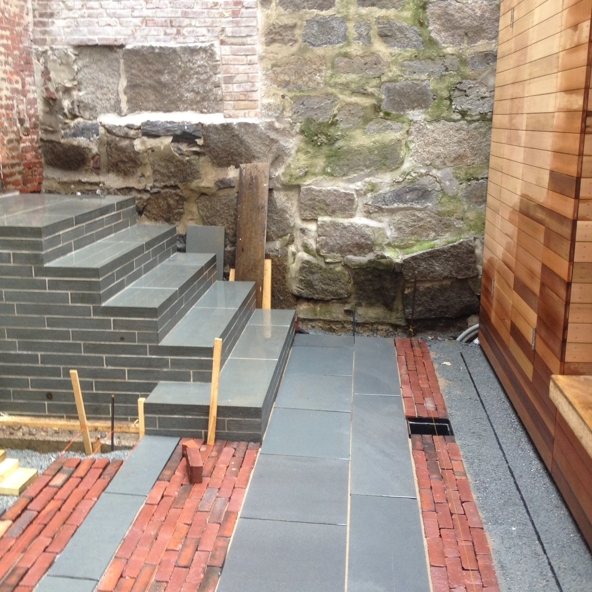 Paving work continues and the completed stair structure.