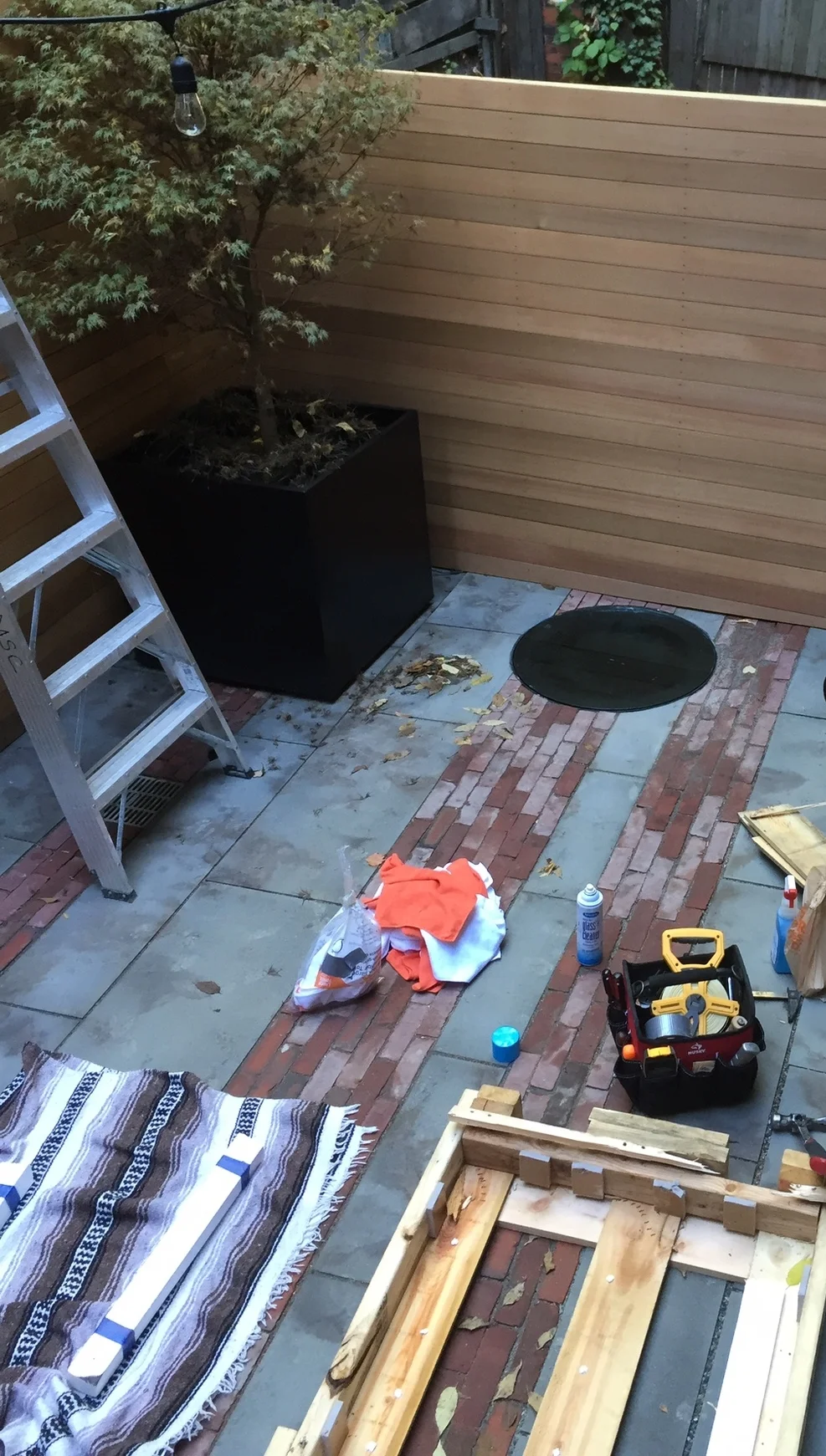 The glass well cover arrives and is installed.