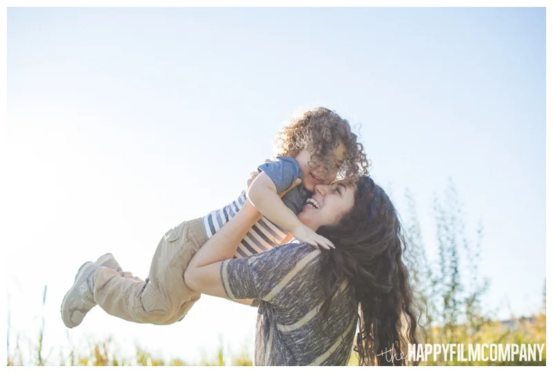 mother son photos throwing kids in the air - Seattle Family Apple Picking Photo Shoot - the Happy Film Company