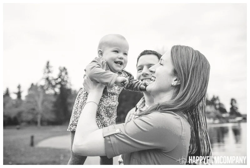 black and white holding baby up in the air smiling happy seattle family photos - the Happy Film Company - Seattle PEPS Group Photo Shoot