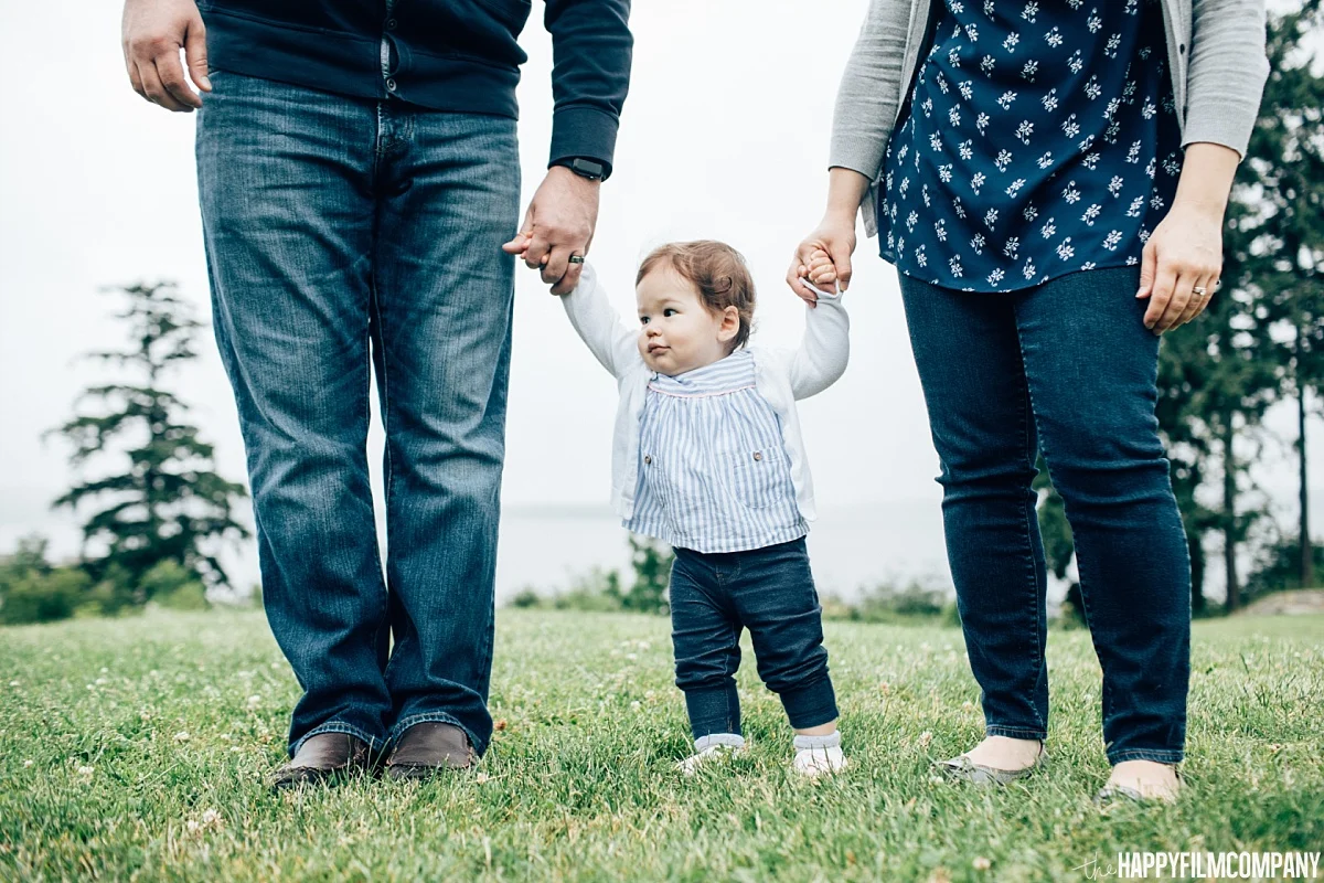 Little girl holding mom and dad's hand - Heritage Park - the Happy Film Company - Seattle Family Photos