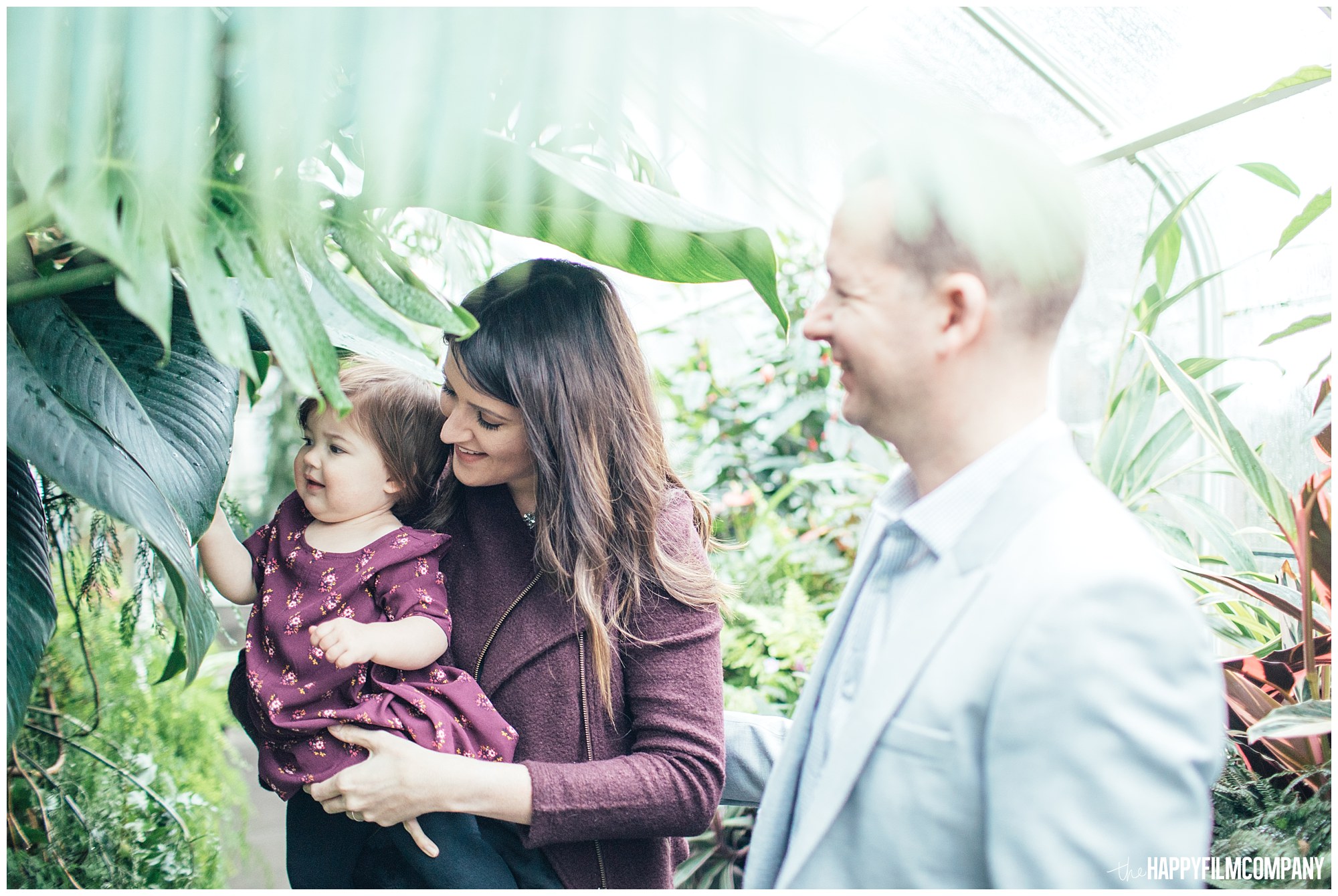 the Happy Film Company - Seattle Family Photos - Volunteer Park Conservatory - family standing underneath banana plant