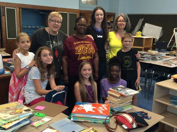 Lauren is appropriately attired in an ioby tee shirt. Ms. Brady, our awesome teacher is wearing the PS 20 tee. DK Holland and Monica Snellings and some of our volunteer kids surround them.