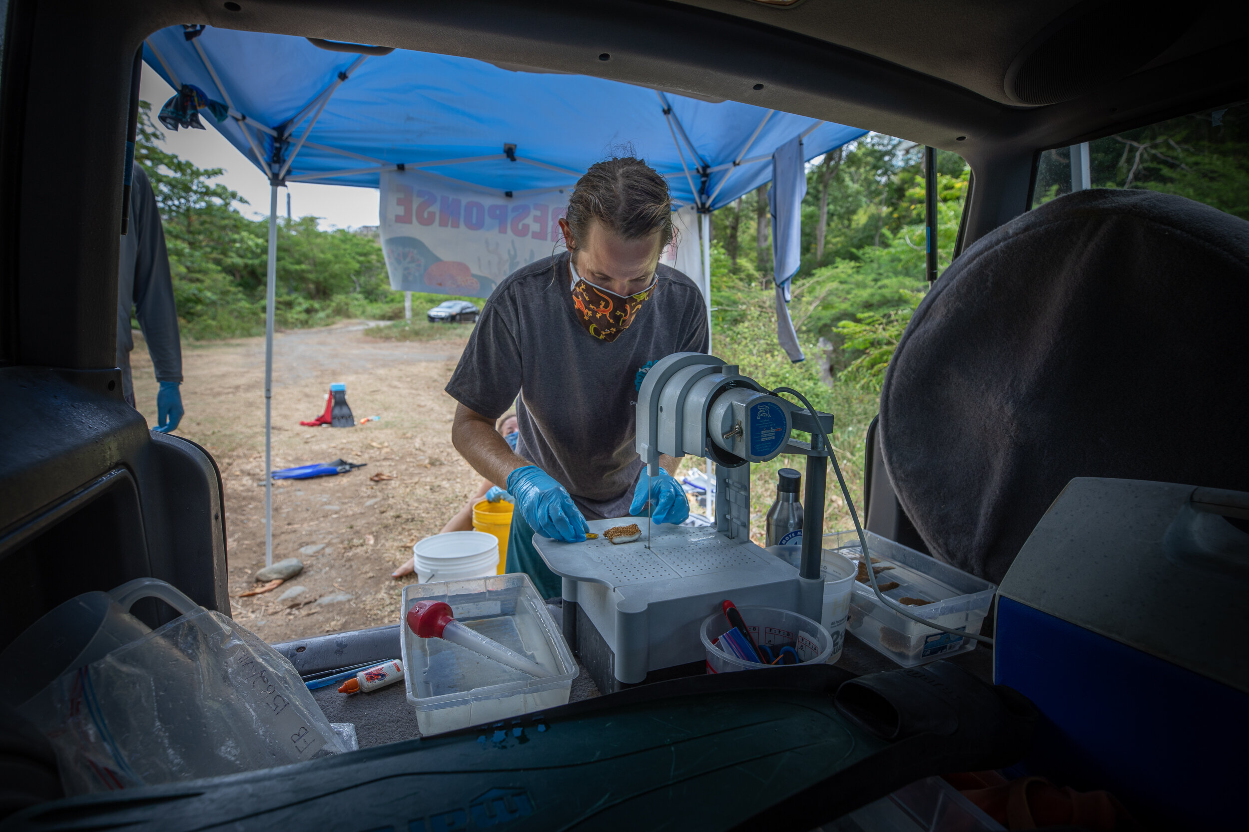  Dan Mele fragments a piece of coral out of the back of his jeep. Photo: Brad Arrington 