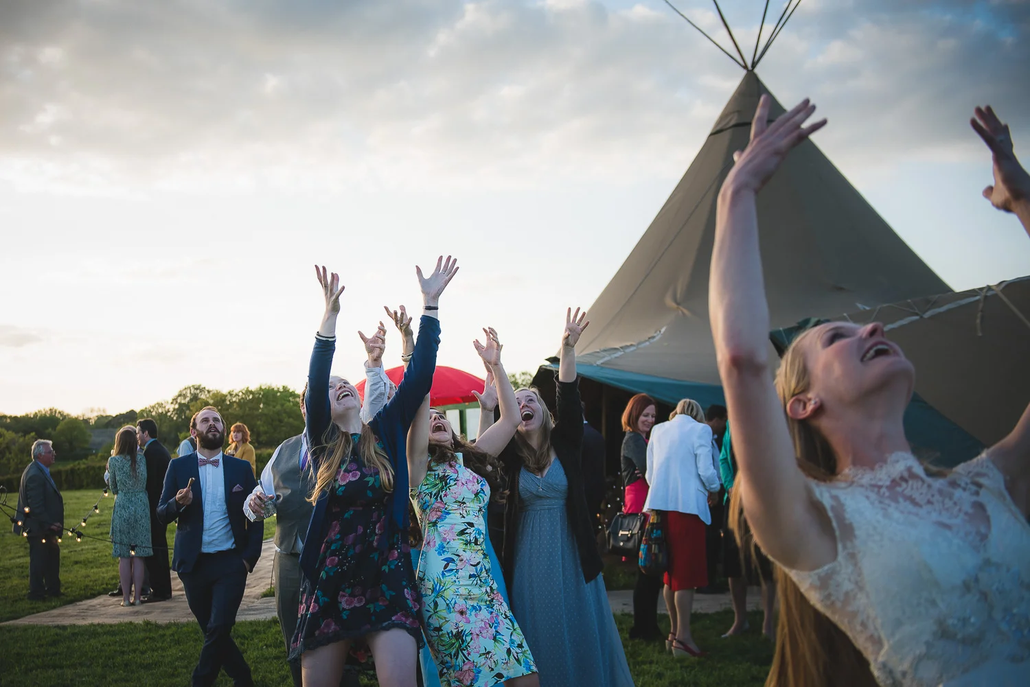 wedding confetti toss in sussex uk with tipi in field