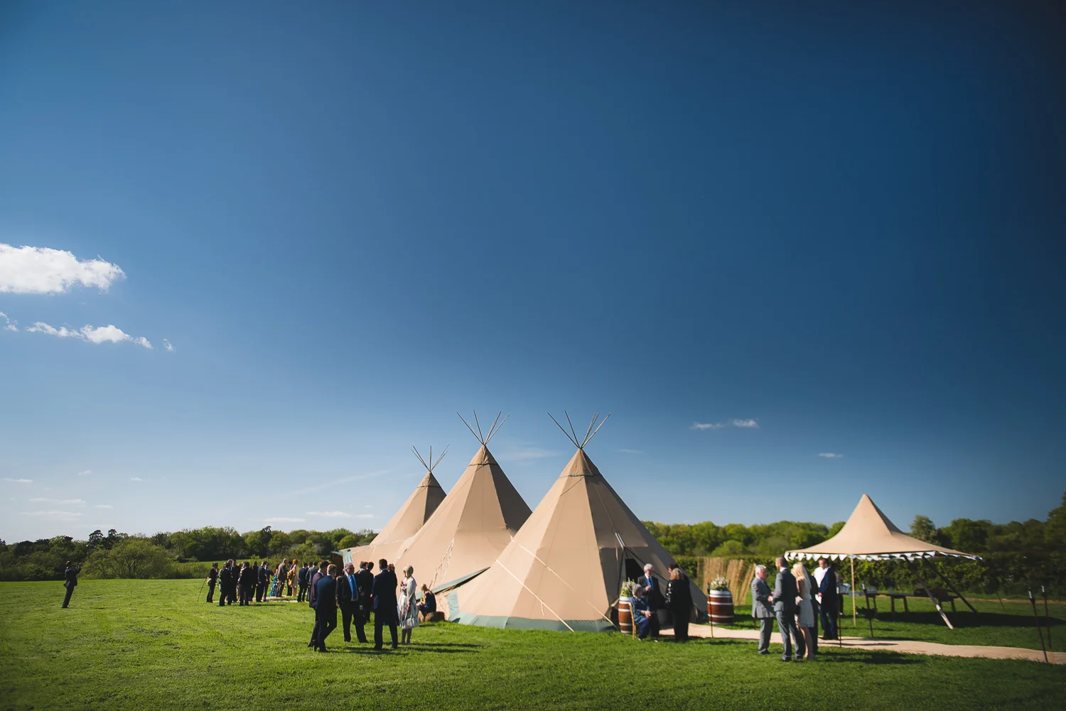 blue sky over tipi at wedding in field