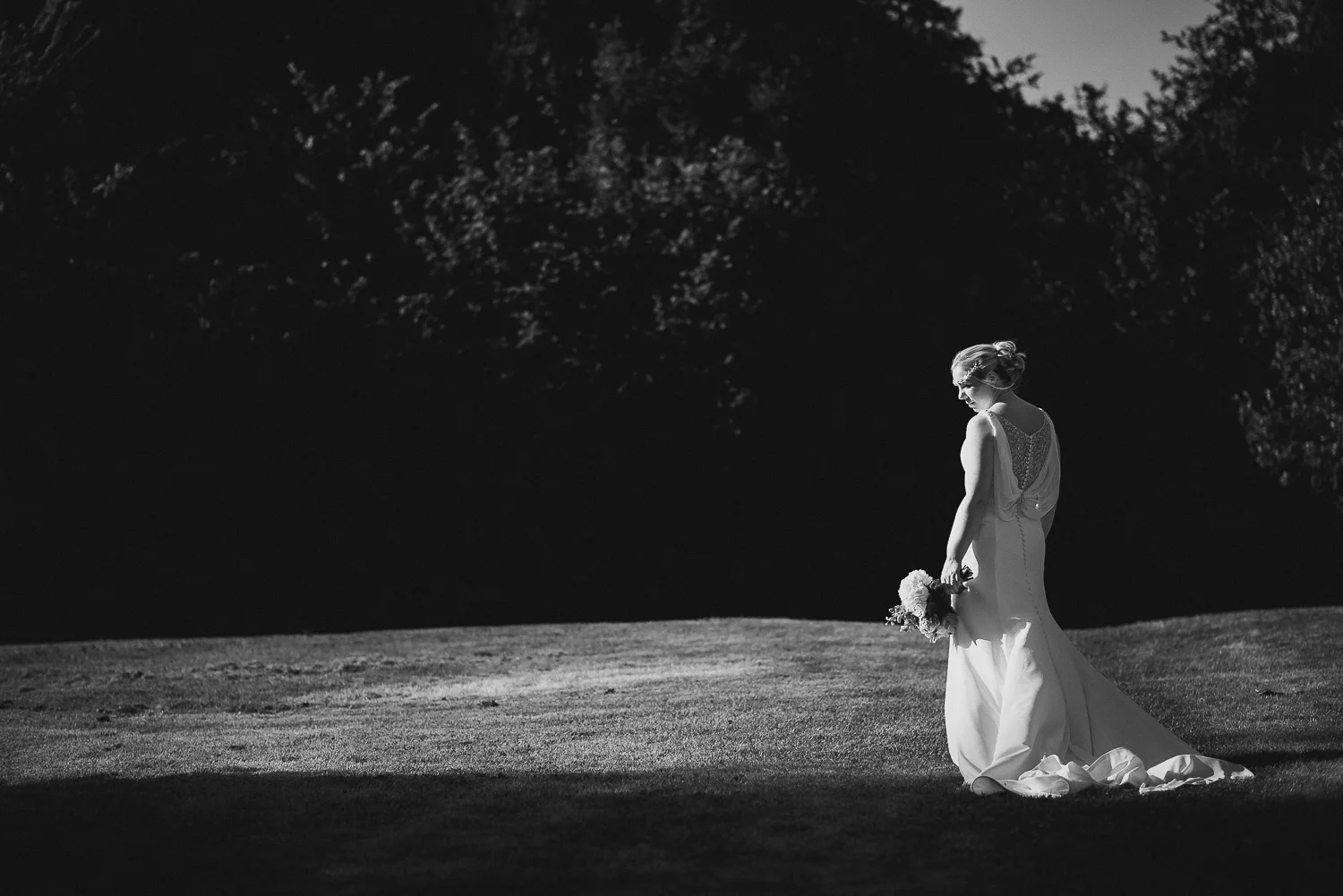 black and white photo of bride in field