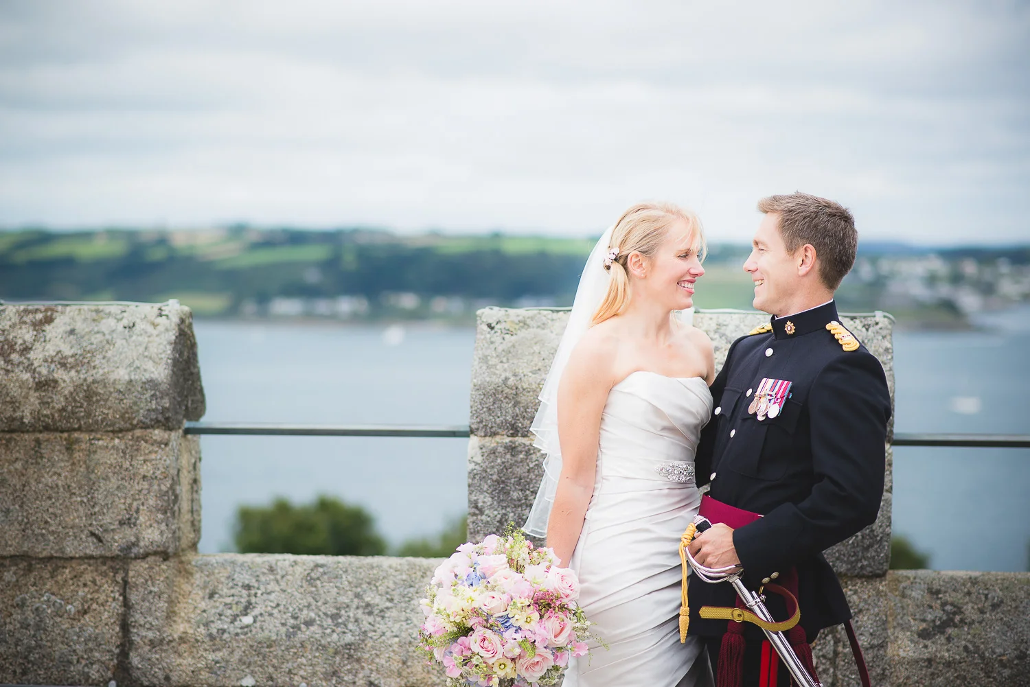 lovely natural photo of army groom and bride at wedding on a castle