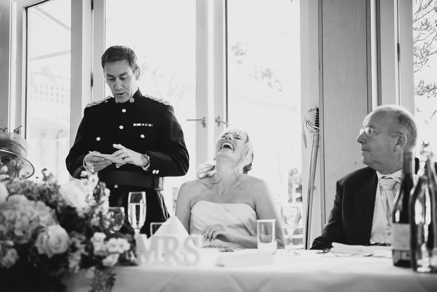 bride laughing at groom's speech during wedding reception in falmouth cornwall