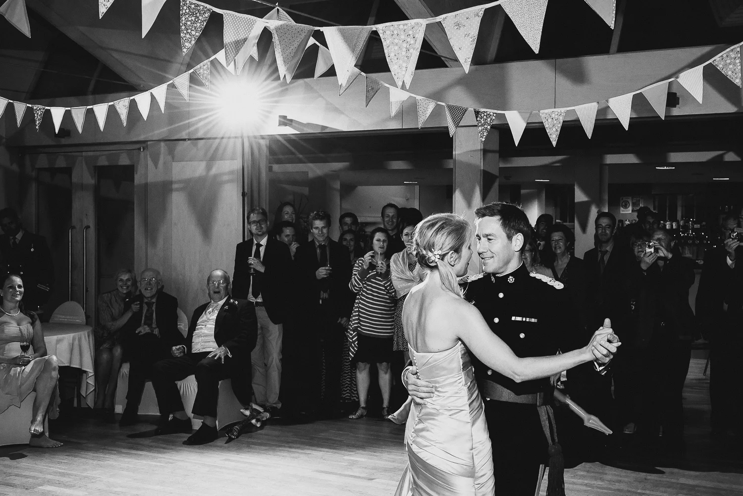 black and white photo of bride and military groom first dance