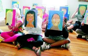   Kids show off their self-portraits at Park Place Arts after a recent class offered there.  