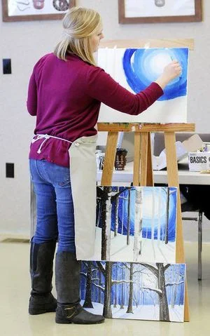   Melody Carr leads her students step by step through the painting of a winter landscape at Mounds State Park on Saturday. The class was so popular that a second was added.  
