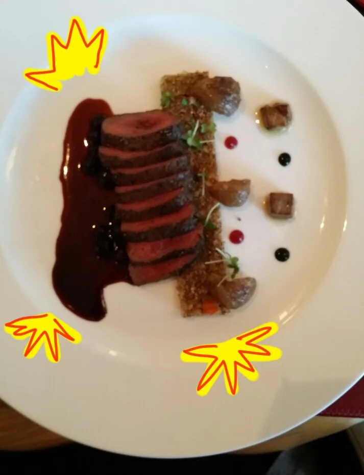 Venison with grains, roasted chestnut and seared foie gras in a huckleberry reduction.