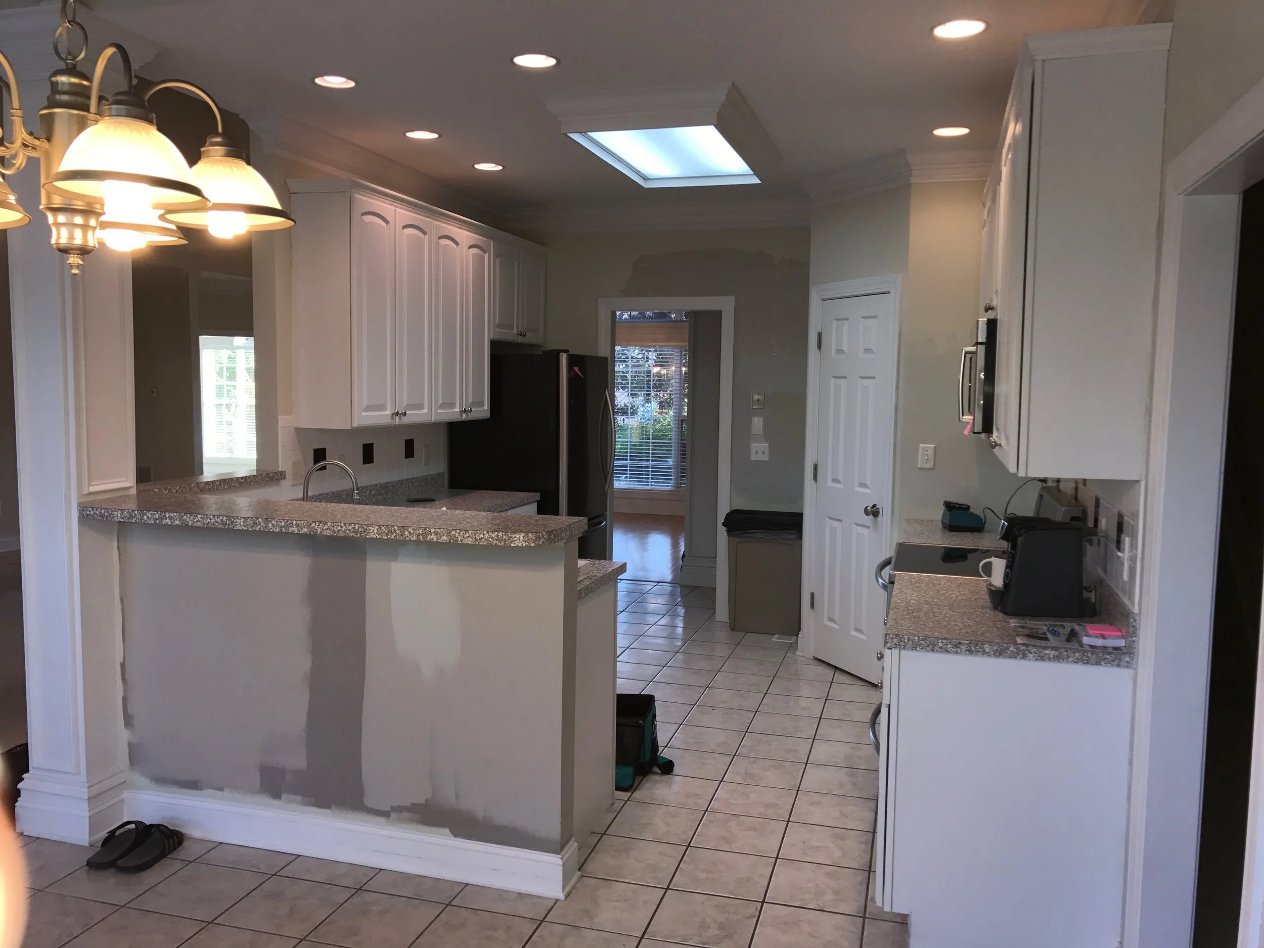 This kitchen also lost a lot of space from an oversized framed corner pantry and raised bar-height knee wall. Although there are multiple openings to the kitchen, it felt quite closed off from the rest of the house.