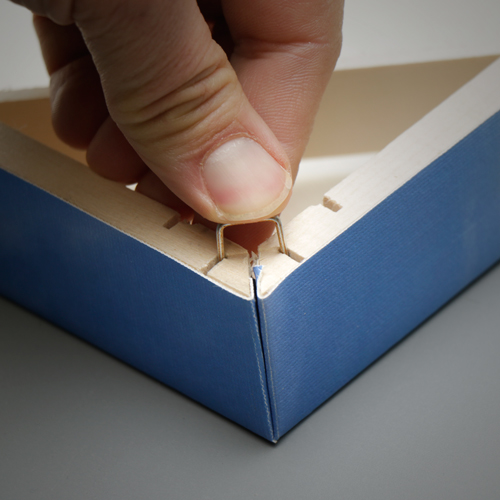 U shaped fasteners allow the canvas to fold into the miter creating neat and perfectly folded corners