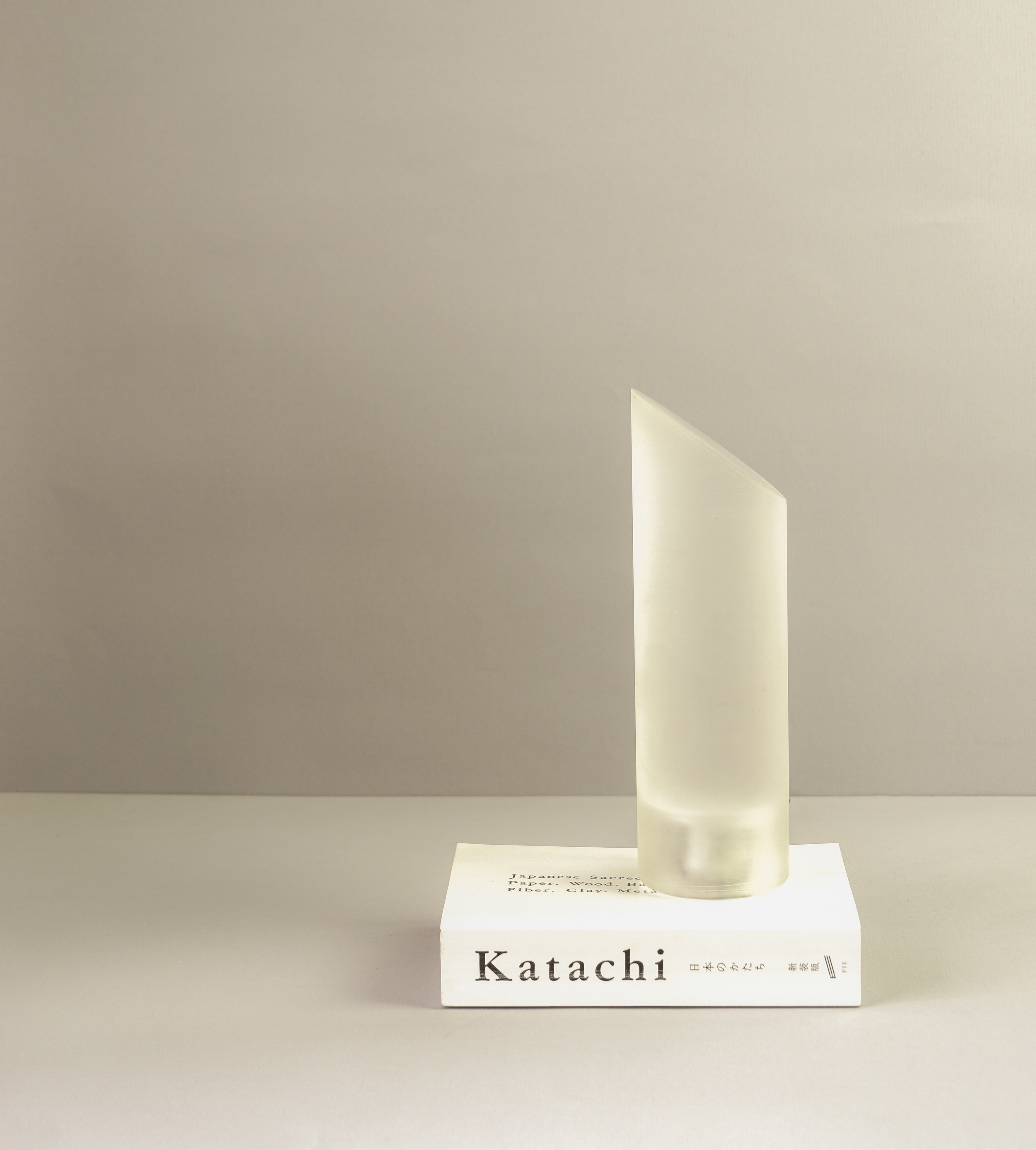 OPTICK Lamp / 2015 This pure and original blend of art and science (optics to be precise) is the result of our exploring and playing with light transmitting through acrylics. It began with an earlier project of ours – Alhazen LED task lamp. ‘OPTICK’ is a versatile lamp, which can be used as a reading lamp or a bed side lamp or on the side table in the living. It has a certain emotion and expression to it and a soft understated and minimal feel, making it is almost inconspicuous. To a person unaware of the principles of light rays, it almost seems magical that the light is reflected on inner surface of a solid block of acrylic at a specific angle. The light rays generate a frustrated refraction. The first impression one can get is – it’s just another soft diffused light side lamp, but in actuality it can focus the light from the single source LED at the base in any desired direction. This makes it a very playful and practical object. It brings a very innovative and fresh solution to lighting. This phenomenon of light transmission has never been explored in its simplicity and effectiveness in lighting. The concept in application is the Snell’s law of Total Internal Reflection (TIR), a unique property of refracting light rays travelling from lower Refractive Index (air- 1) to the denser medium with higher Refractive Index (acrylic- 1.492). The angle at the top which is little over the critical angle for Refraction for Acrylic. That is about - 42.4 degrees.
