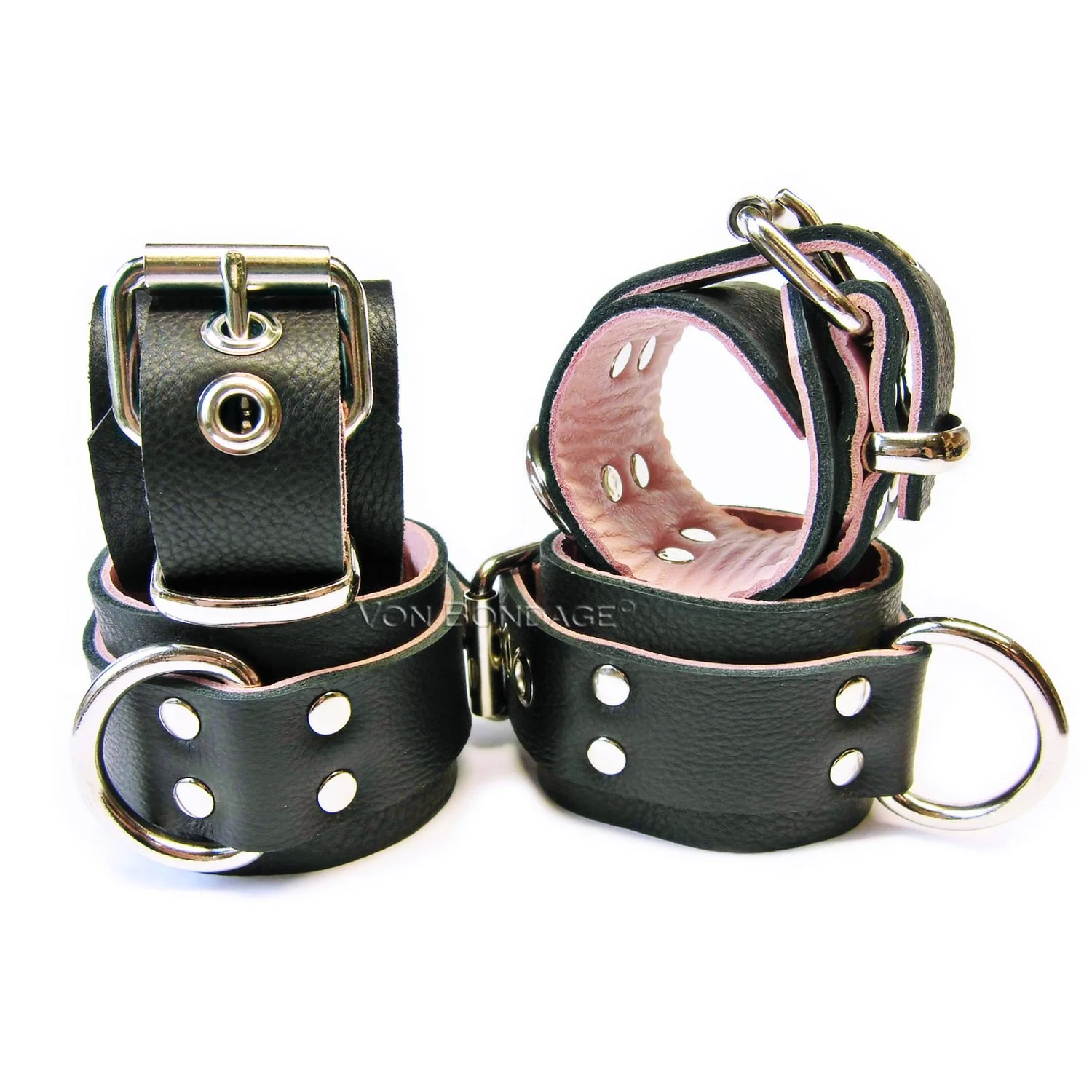a set of wide wrist and ankle restraints with large dee rings lined in pink leather