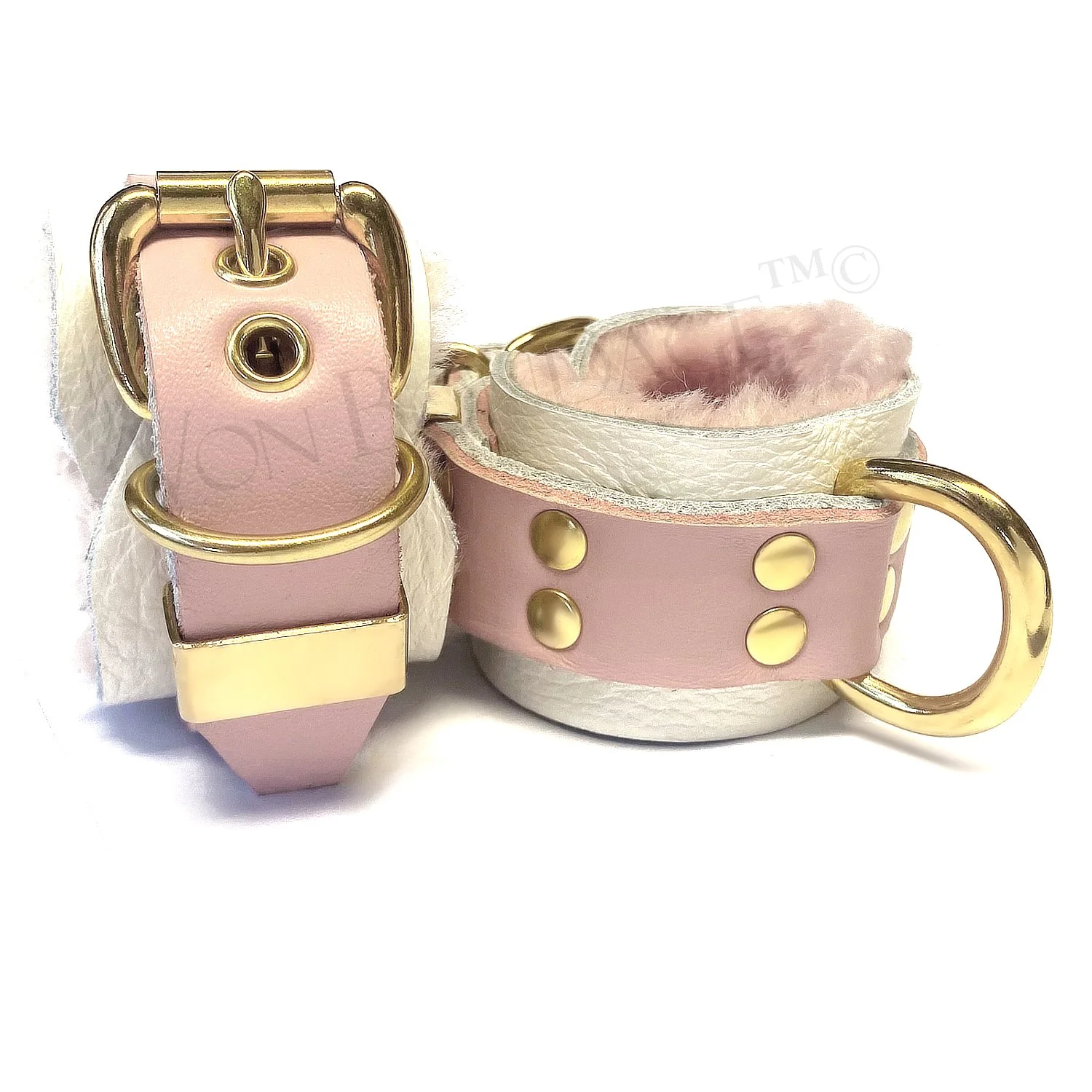 Fur-lined in restraints in brass, pink sheepskin, pink and white leather