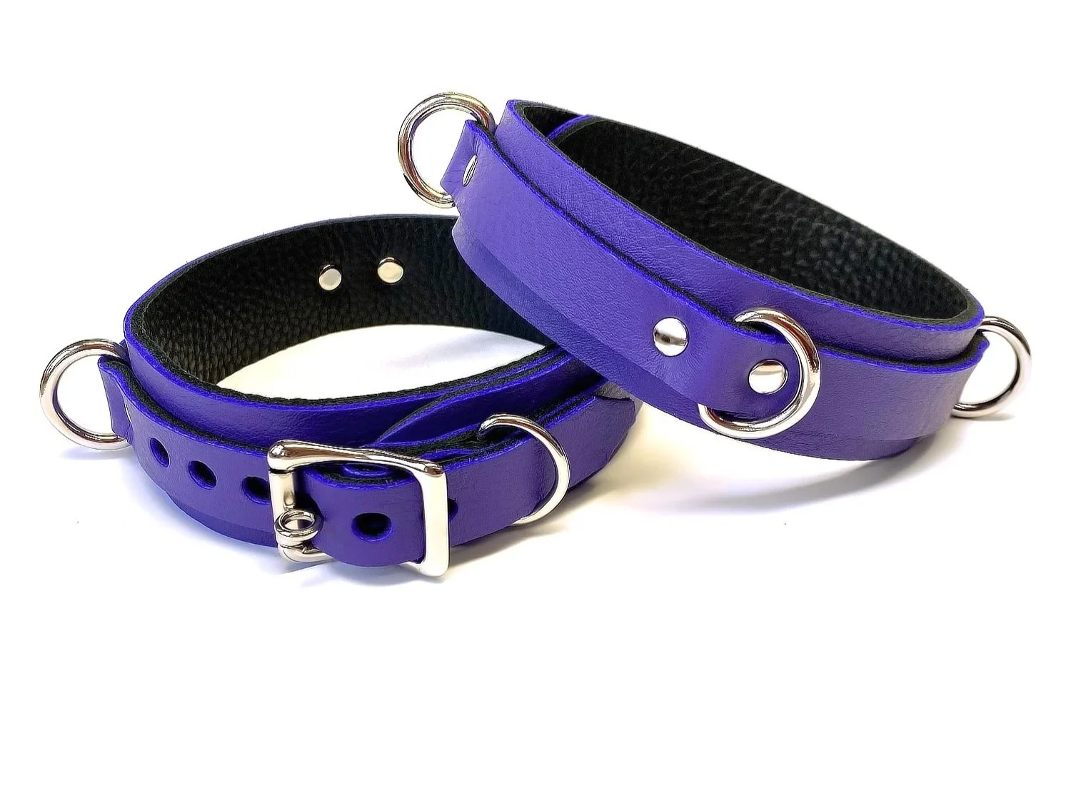 pair of purple leather thigh restraints with 3 rings