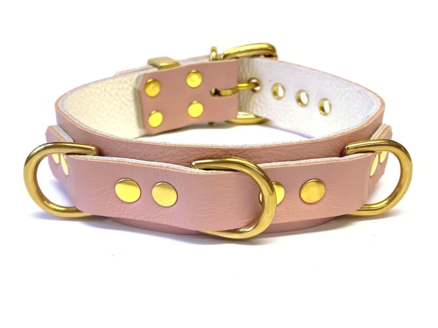 pink leather bdsm collar with 3 brass d-rings across the front