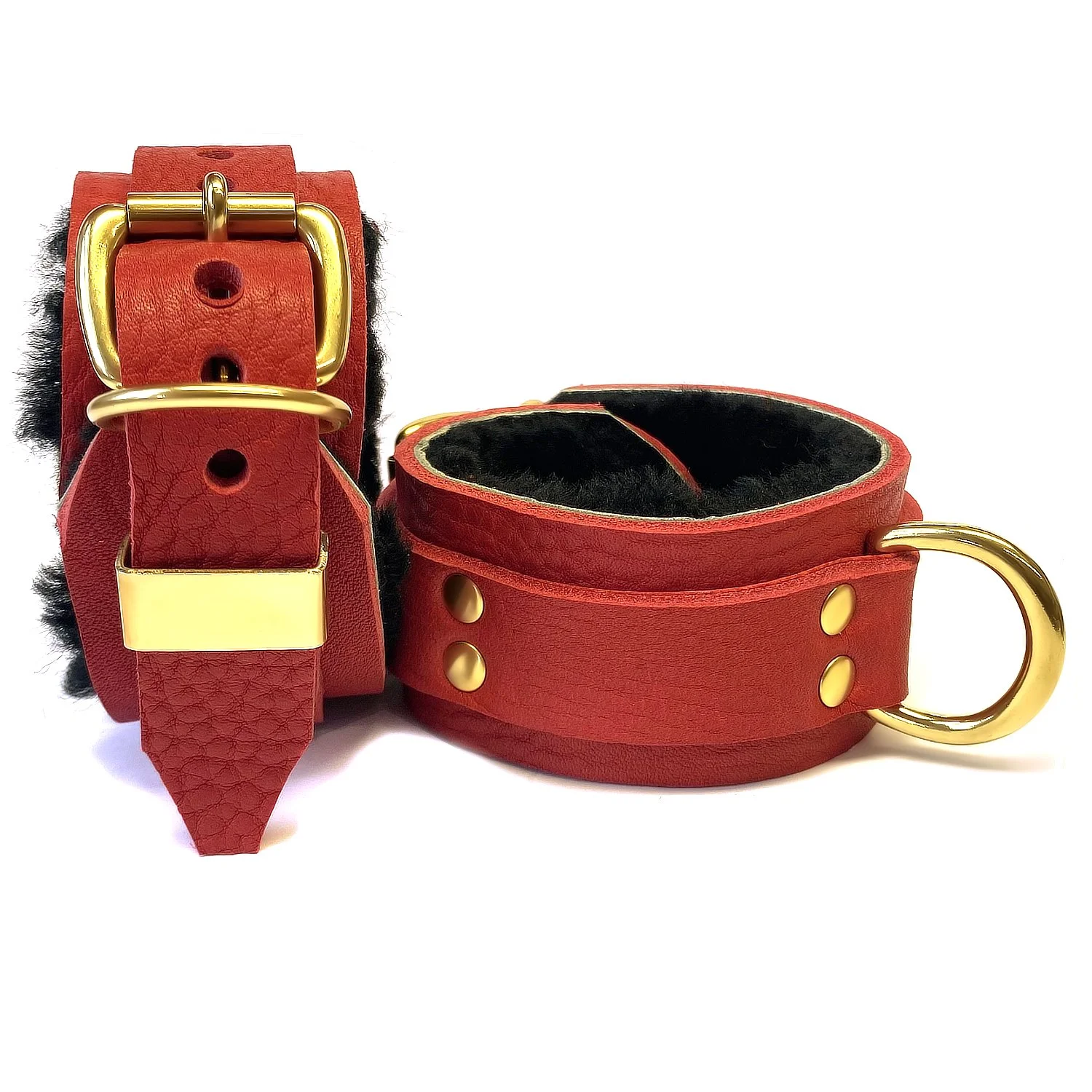 Fur-lined in restraints in brass, black sheepskin, red leather