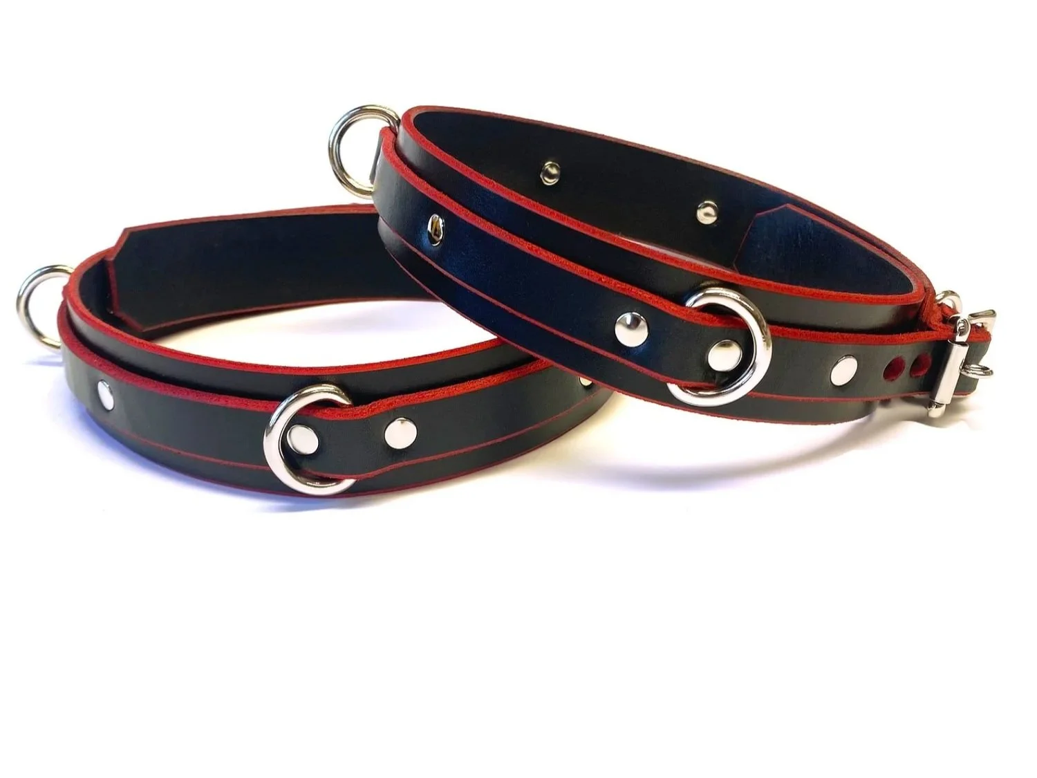 Leather thigh restraints with red edges and 3 d-rings per cuff