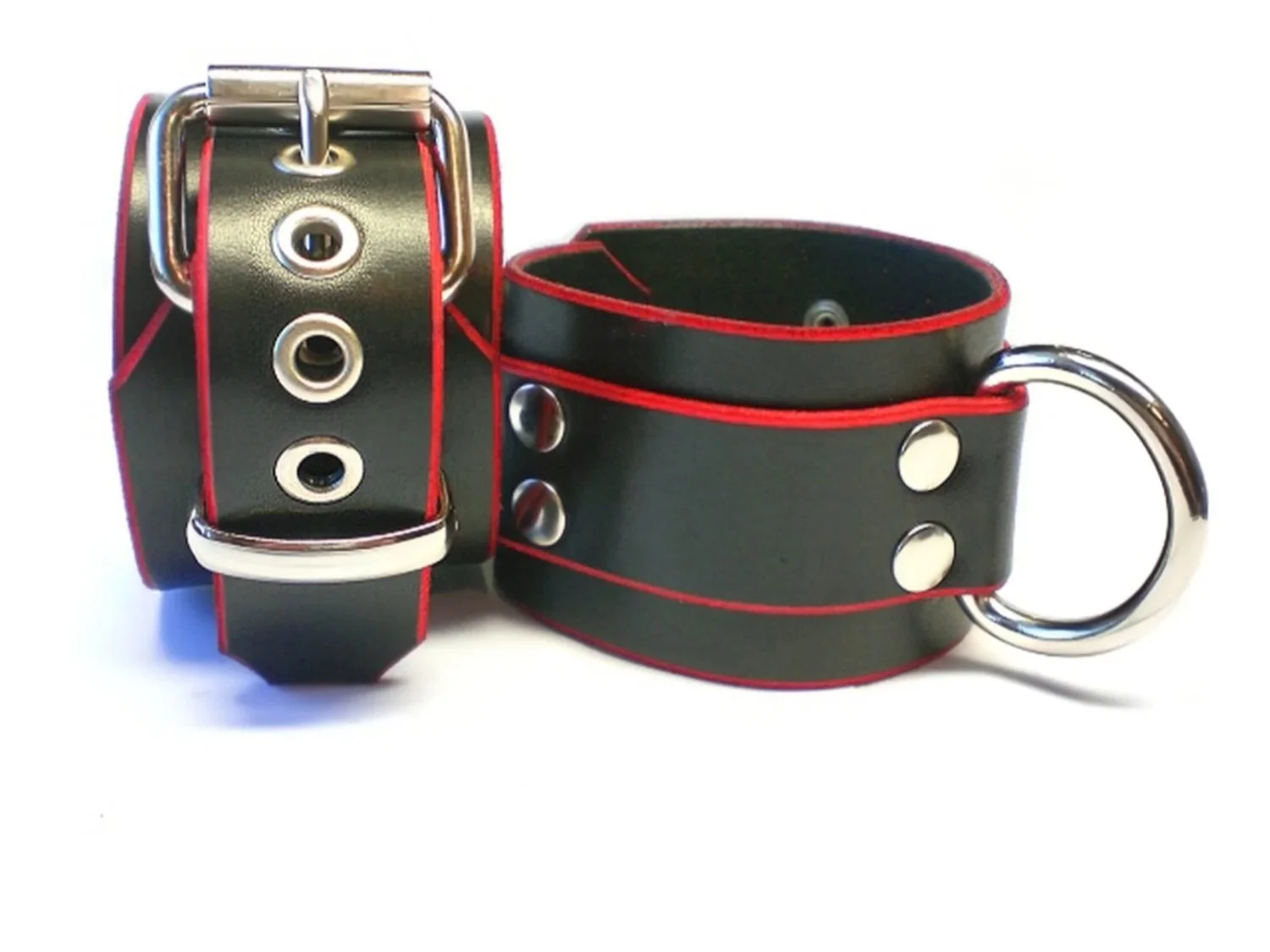 pair of black leather bdsm restraints with red edges and large d-rings