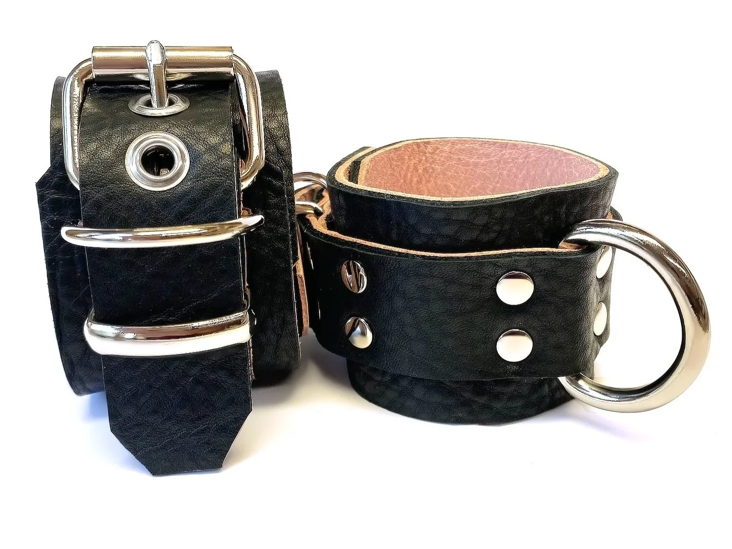 Pair of wide Restraints lined in pink leather with large d rings