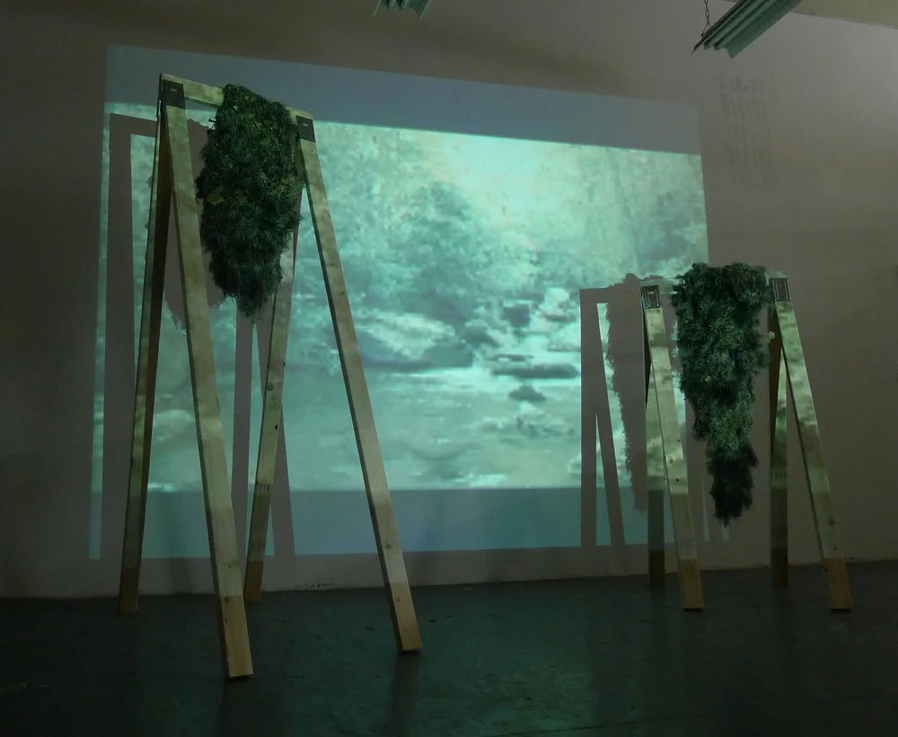   Deer Bark  2011 One channel video/audio, wood, ghillie suits Dimensions variable 