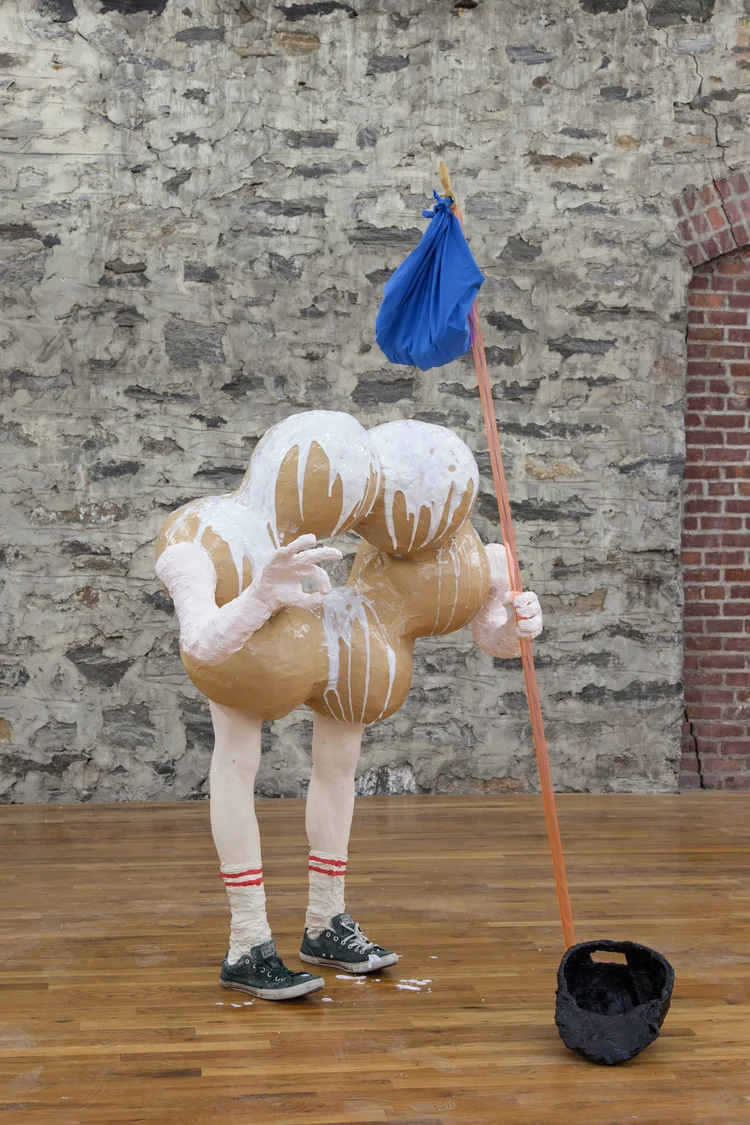 Carol Hou & Izabelle New Runaway Donut Runs Away for the First Time 2013 Paper mache, plaster, enamel paint, sneakers, acrylic rod and rock sack 78 x 45 x 43 inches