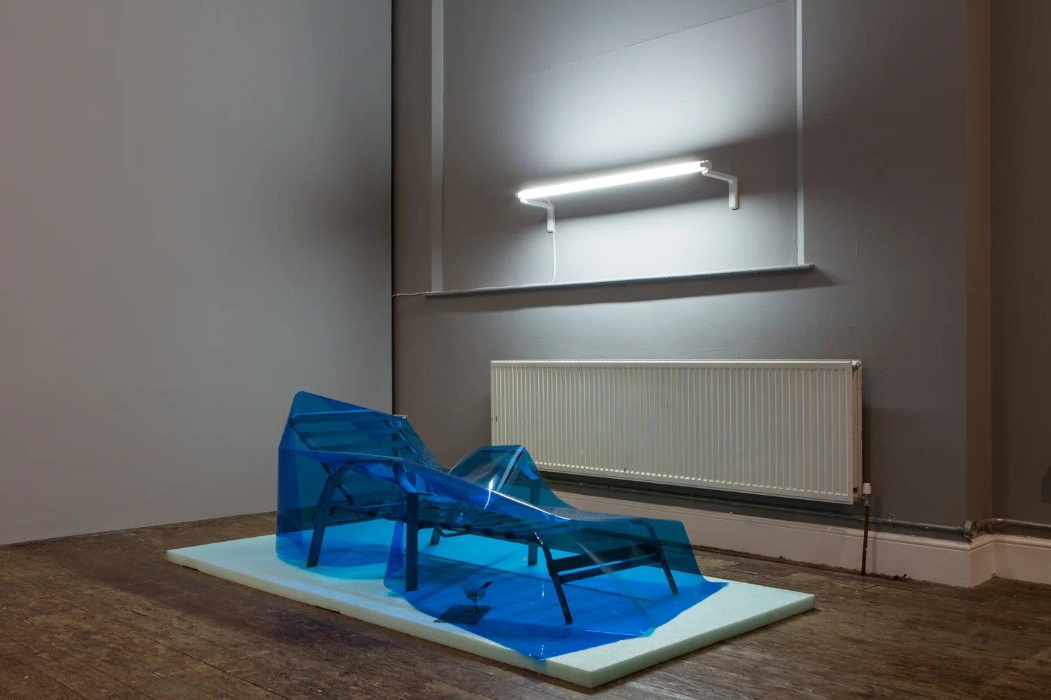 Dominic Samsworth Condo Glut , 2014 Packing foam. sun lounger, flourescent light, UV lighting, gel, plastic tray, glasses, Dirty martini - Red Hook water, gasoline, abalone shell 26 x 97 x 48 inches