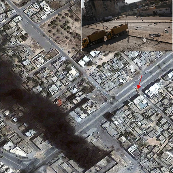 Using the UNOSAT Cybrmappr crowdsourcing application, a photograph of dump trucks used as a blockade in Misratah is precisely located in a satellite image from 23 April 2011 (see red arrow) | Courtesy of UN Institute for Training and Research, Satellite image copyright DigitalGlobe, 2012