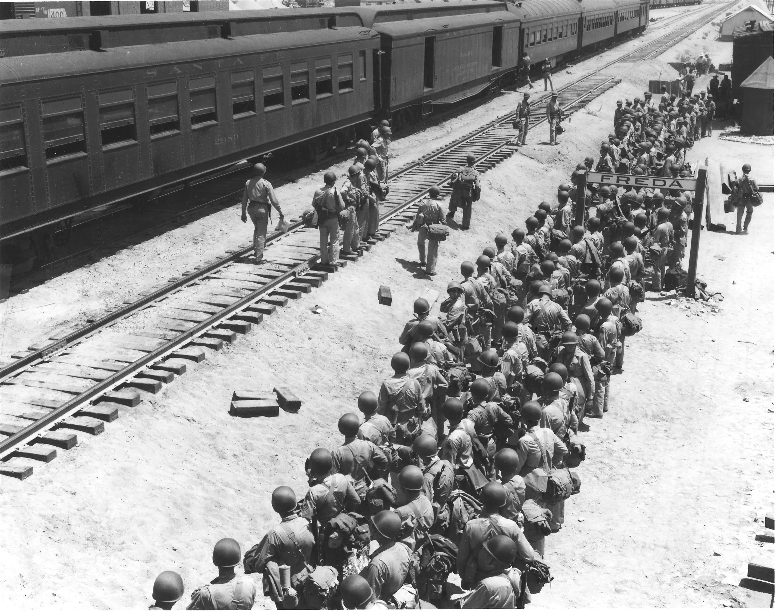 Soldiers disembark at the Freda railroad siding, off what is now Highway 62. Established railroad lines made the Desert Training Center ideal for transporting troops and equipment. U.S. Army photograph, courtesy of the General Patton Memorial Museum.