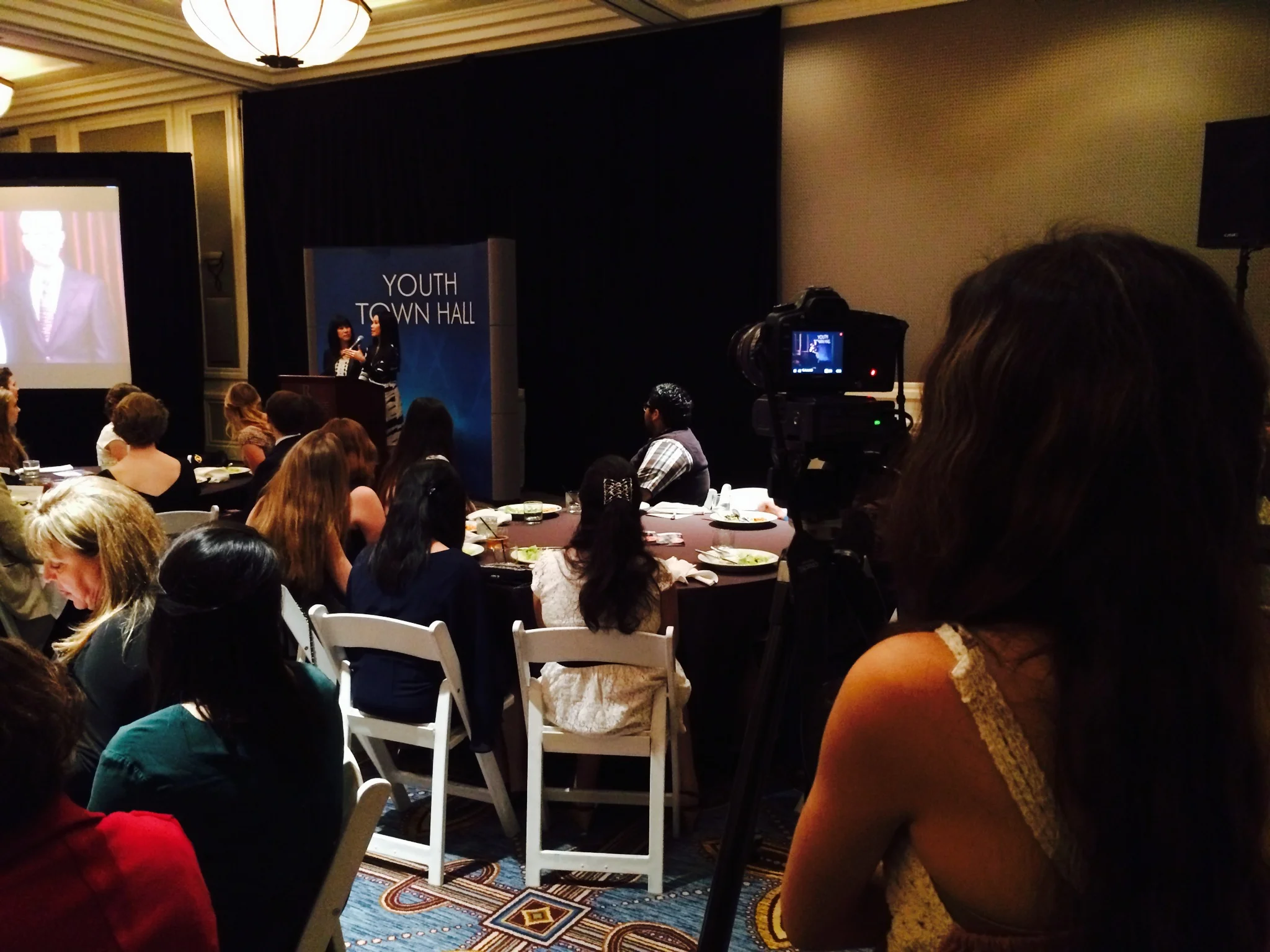 Ariana Davis working as a camera operator during the Ling sisters' Q&A session with local high school students