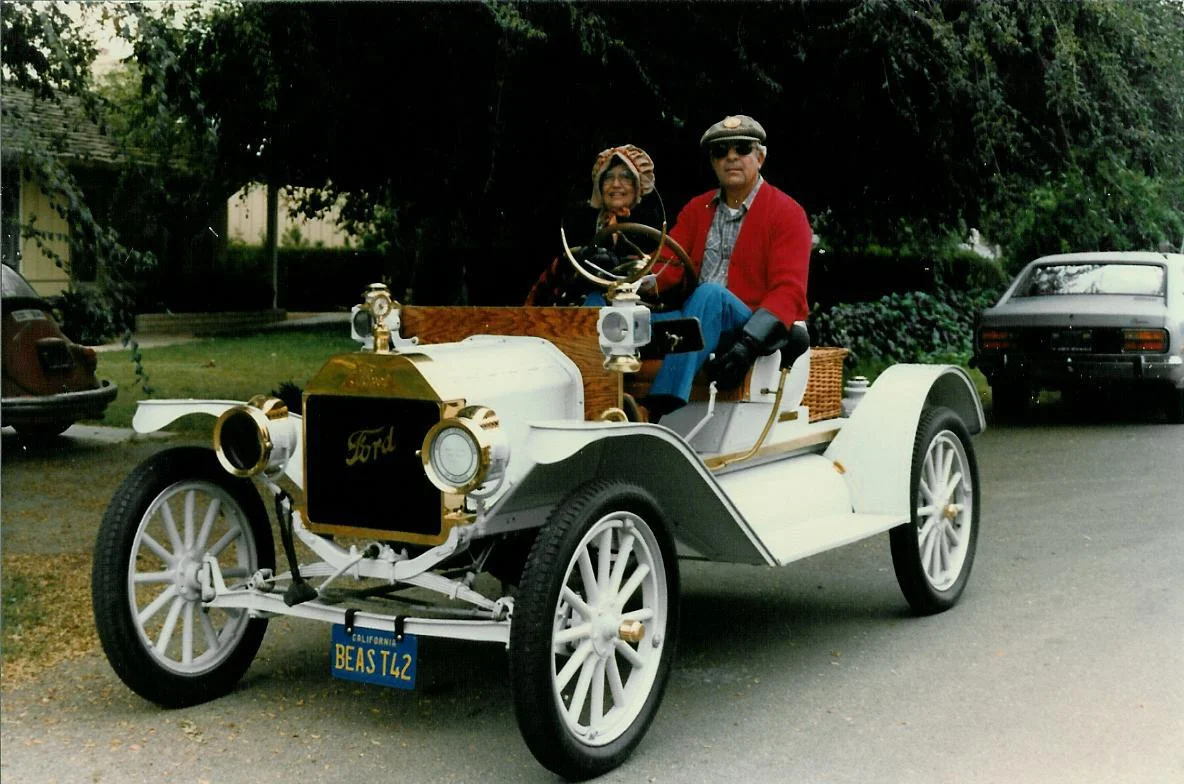 This is my wife and me in front of our house a while back in the 14 speedster. The license plate reads Beast42. My wife's name is Bea, and this is her T for two.