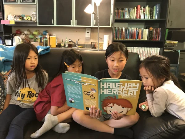 Enjoying Halfway Herbert in Bibliopolis. Books range from picture books for elementary school kids to chapter books for older students.