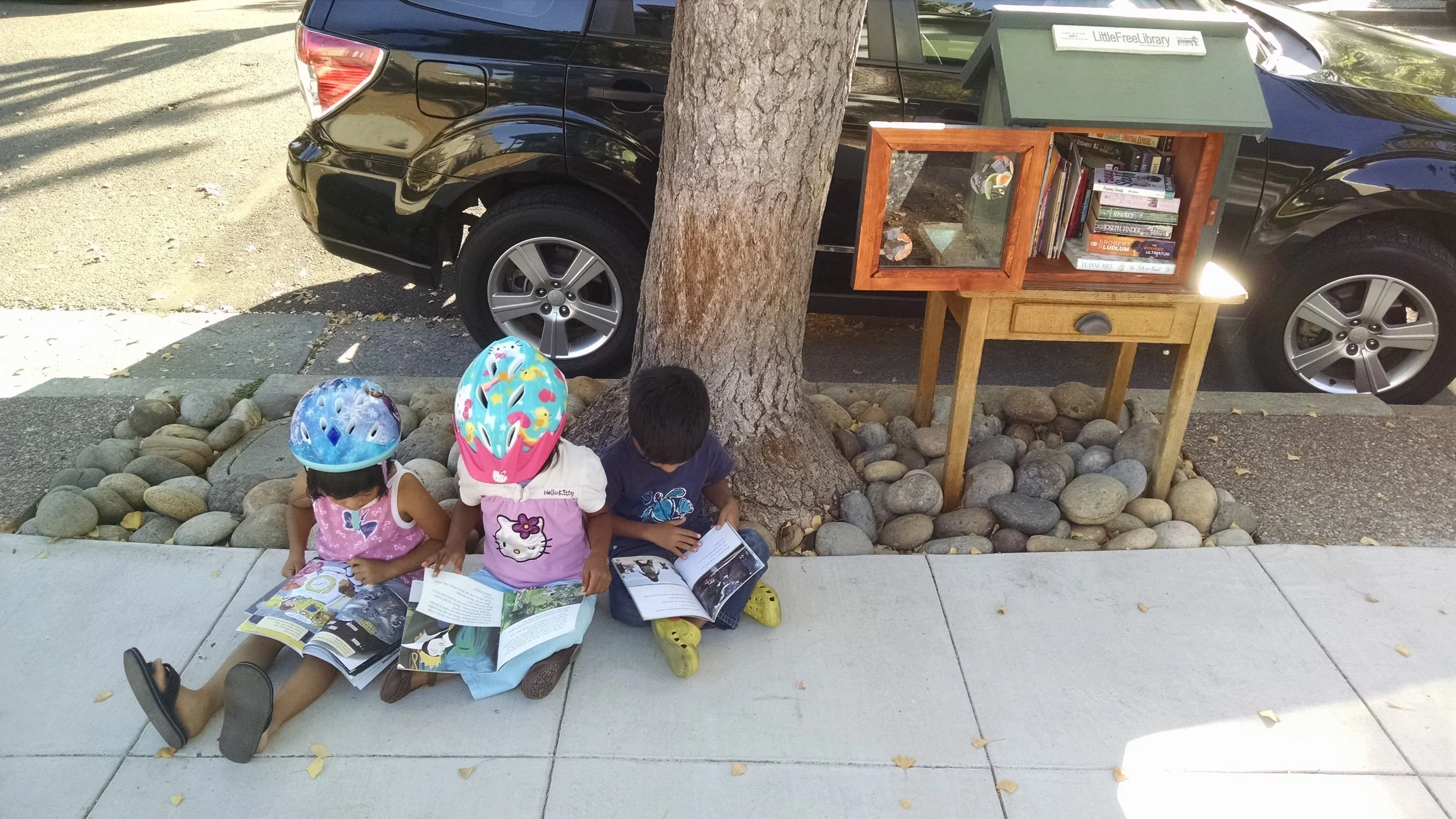 Anywhere in the world can become a place to "steal a reading moment." Even during a bike ride in Alameda!