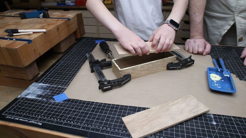 Setting the 1/4-inch oak top onto the glued carcass