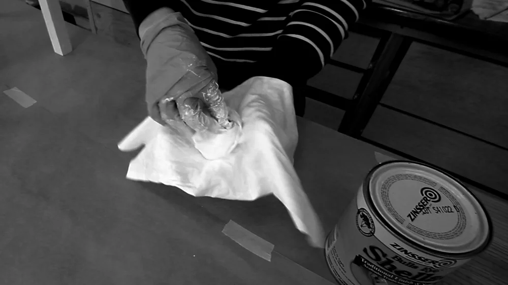 Creating the pad by enclosing one towel inside another.