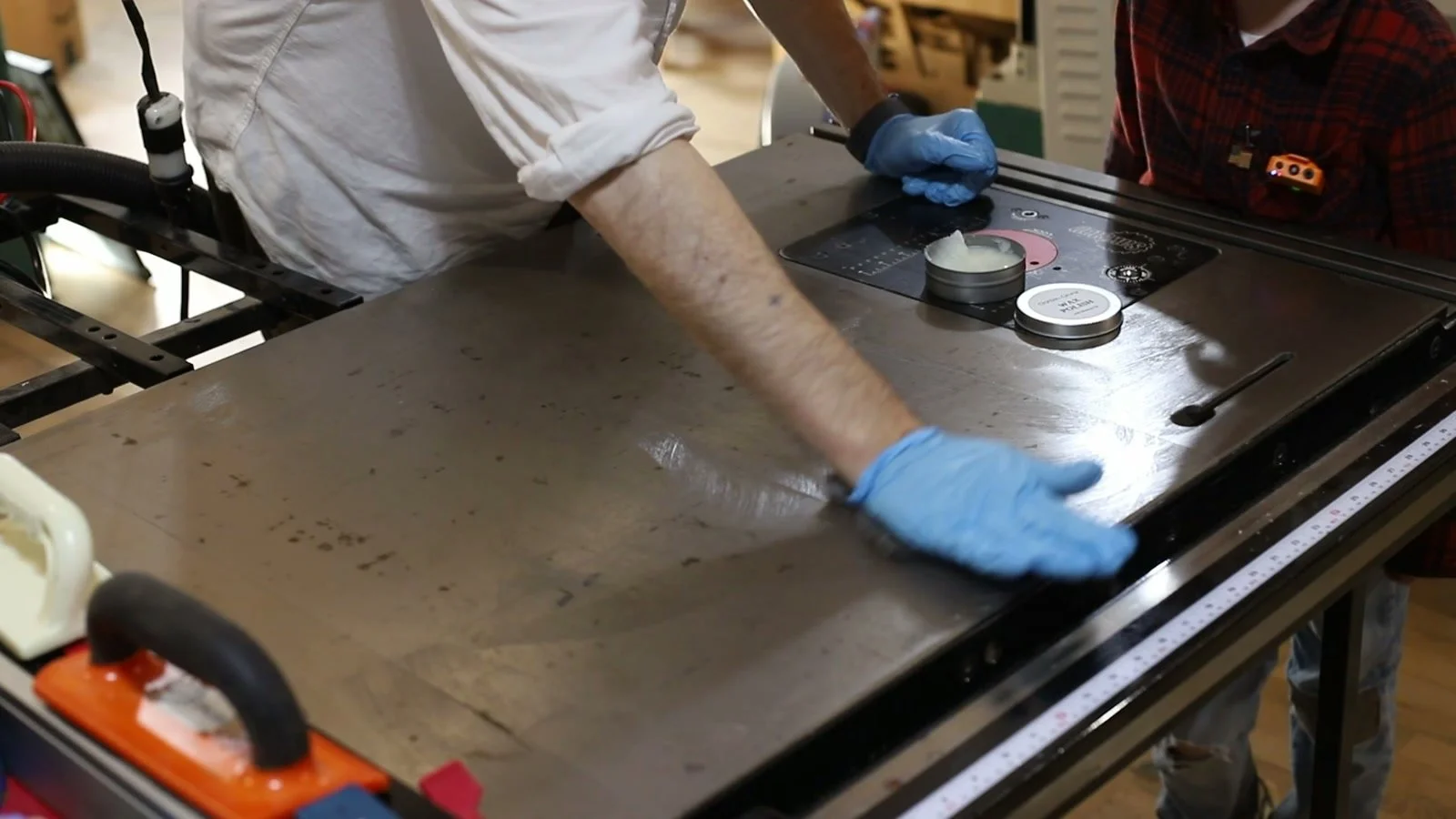 Applying mineral oil and beeswax polish to a table saw top