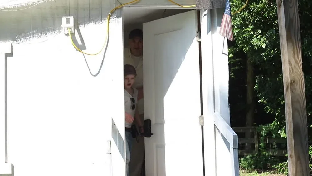 The finished white exterior door installed on the playhouse