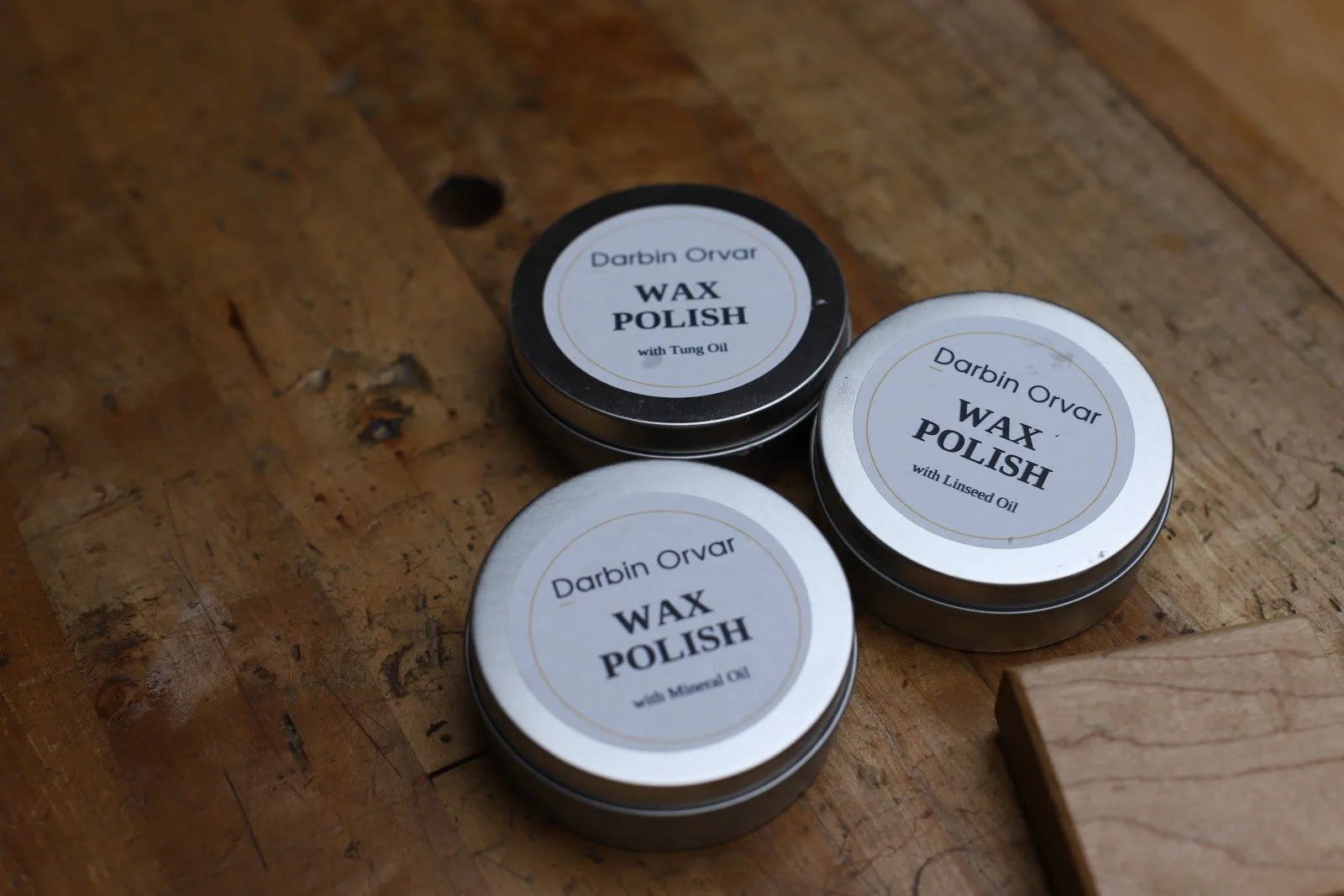 Three beeswax polishes made with mineral oil, tung oil, and linseed oil