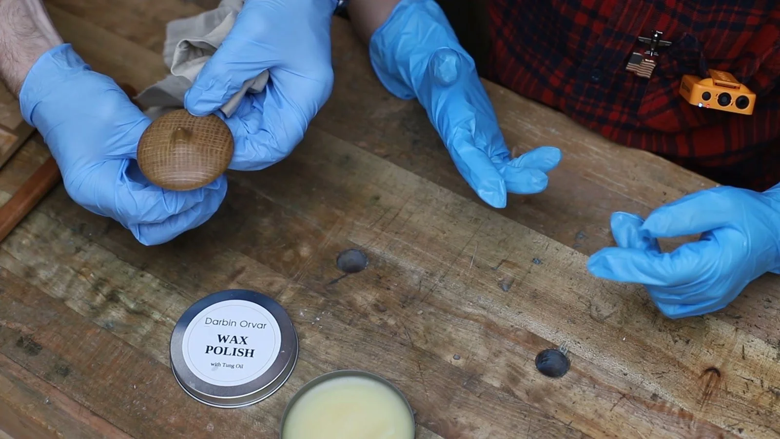 Tung oil and beeswax polish beside a wooden spoon